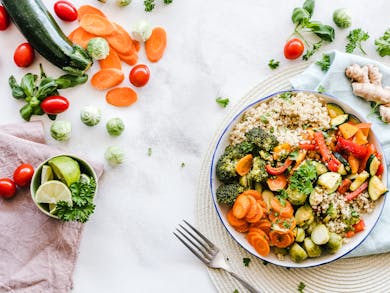 Colorful quinoa salad with fresh vegetables creates a healthy, balanced meal.